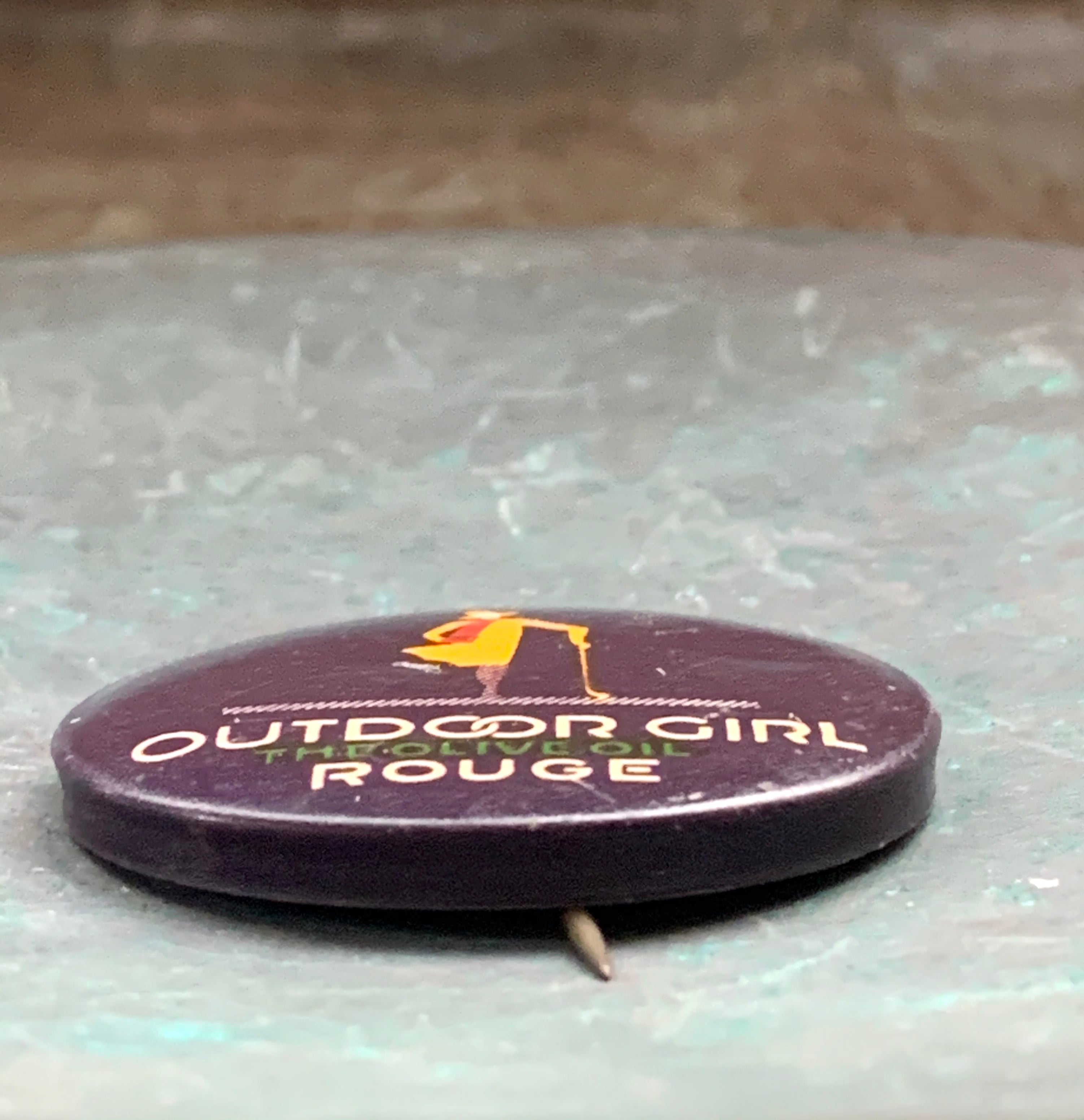 Vintage "Outdoor Girl, The Olive Oil Rouge " Pinback Button