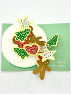 A set of three-dimensional pop-up greeting cards featuring a Christmas cookie design with green envelopes and the text 'Merry Christmas' on the inside.