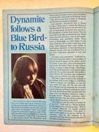 Page from a book or magazine with text and a photo of a person, featuring the title 'Dynamite follows a Blue Bird to Russia'.
