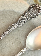 Decorative silver spoon on a textured surface