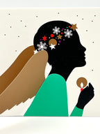 A greeting card featuring a stylized illustration of an angel with wings, wearing a green outfit and holding a star. The background is white with decorative elements.