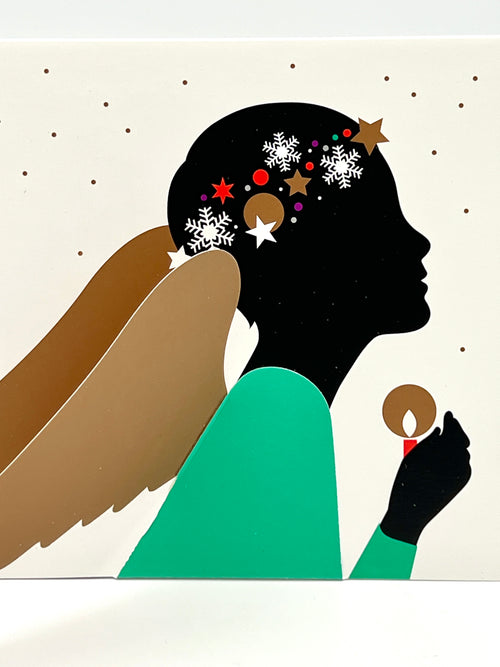 A greeting card featuring a stylized illustration of an angel with wings, wearing a green outfit and holding a star. The background is white with decorative elements.