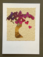 Valentine's Day Card with a tree made of heart-shaped cutouts on a textured beige background