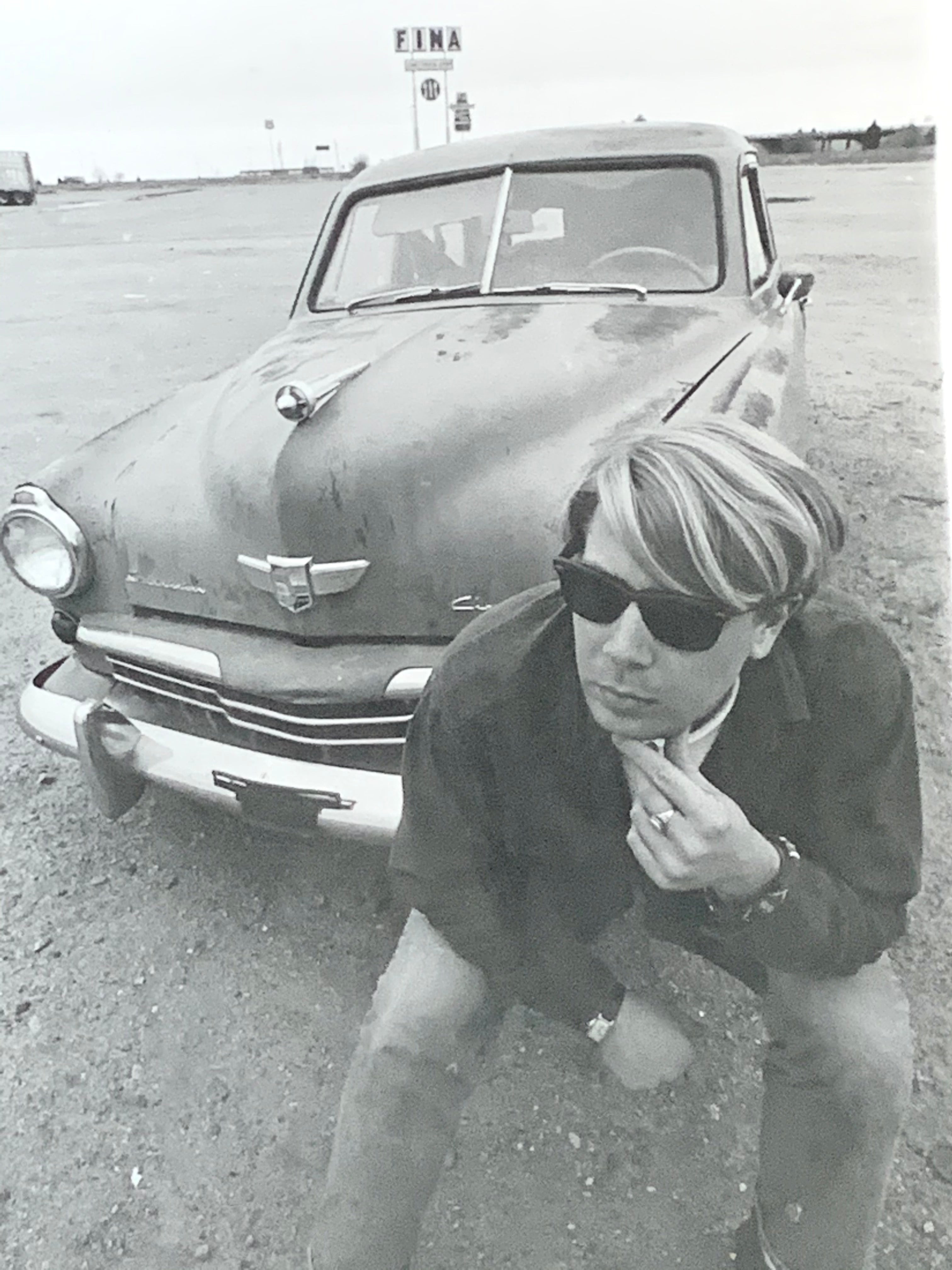 Black and White Photograph of Man w/ Vintage Classic Car; Fina Station Sign